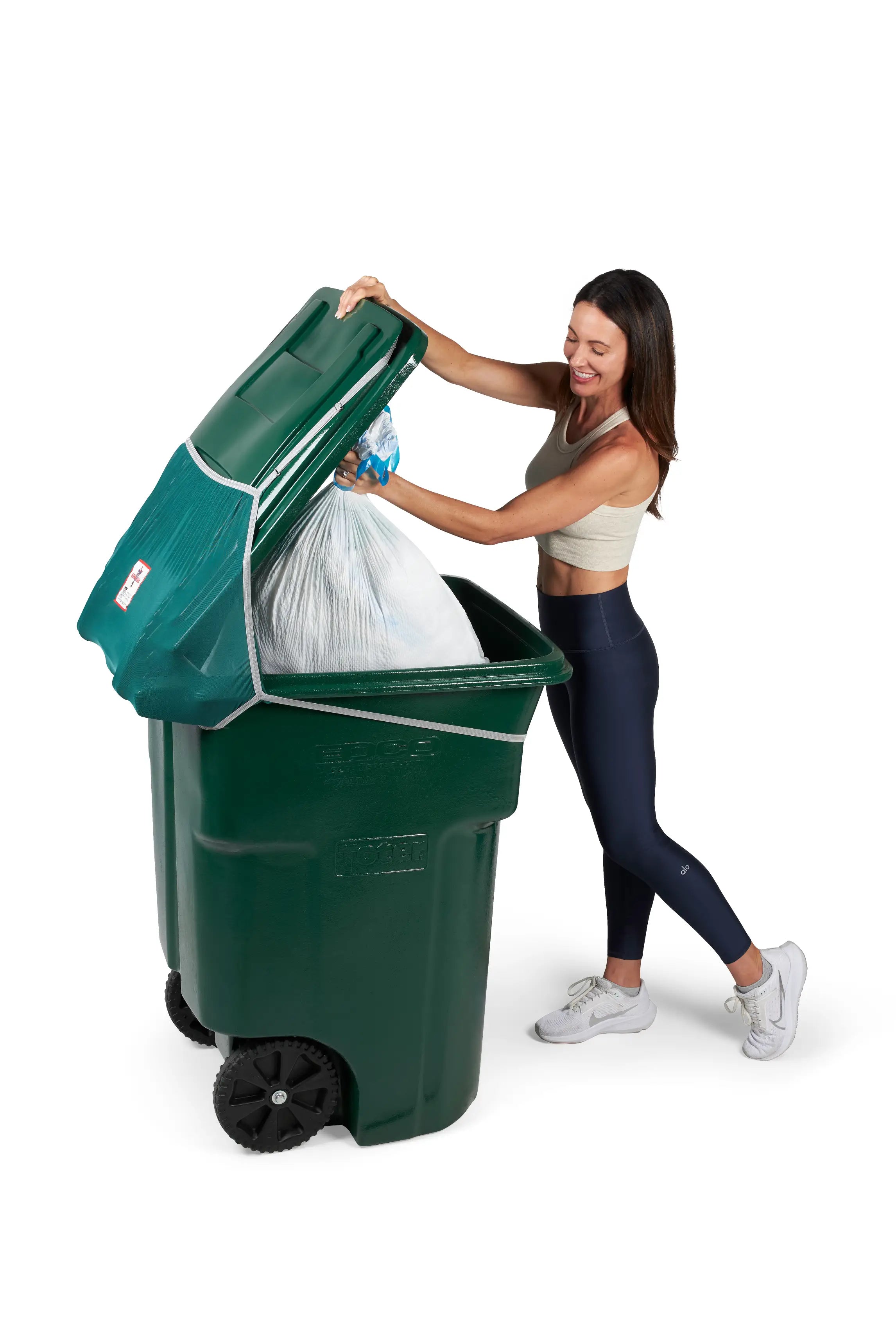 Woman easily places trash bag inside her trash bin with Bin Hero installed