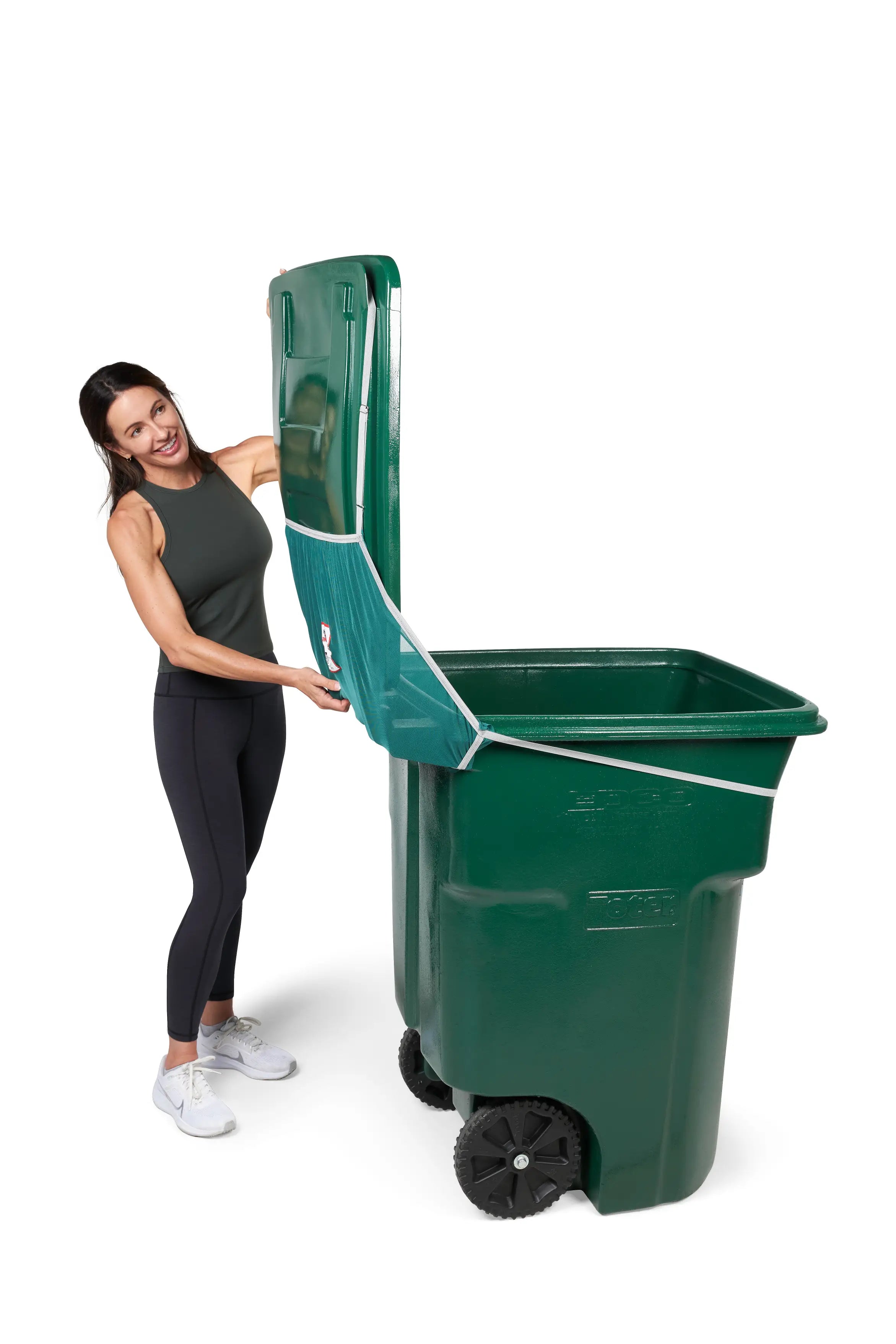 Woman easily opens her green trash bin lid 90 degrees with Bin Hero installed.