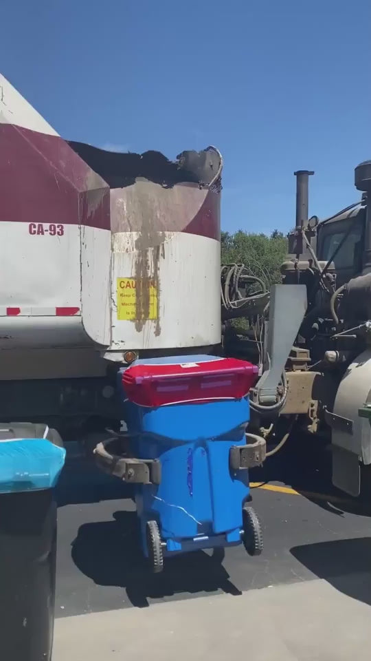 Bin Hero product installed on a trash bin stays in place as a trash collection truck picks up and flips the trash bin to empty it.